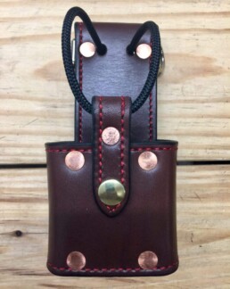Leather tool pouch with brass and copper rivets.