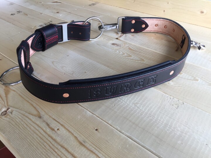 Black leather weightlifting belt on table.