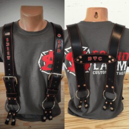 Leather suspenders on mannequin with printed shirt.