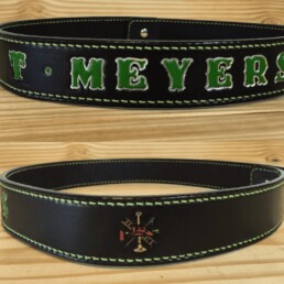 Black leather belt with green lettering.