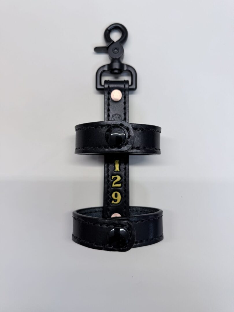 Black leather holder with number 129.